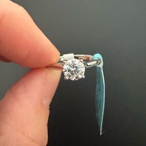 Size 6 Solitaire Round Moissanite Engagement Ring in 925 sterling silver band.